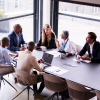 Group of people around an office table discussing