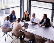 Group of people around an office table discussing